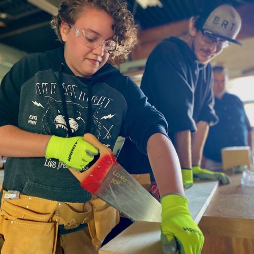 Focused training in progress at ReSOURCE Vermont, where individuals learn valuable construction skills, contributing to workforce development and sustainable job creation.