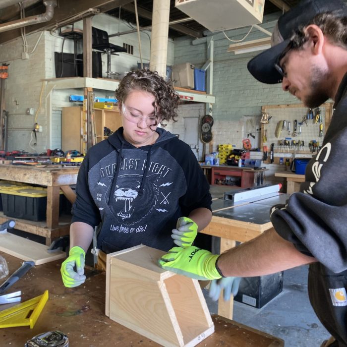 Focused training in progress at ReSOURCE Vermont, where individuals learn valuable construction skills, contributing to workforce development and sustainable job creation.