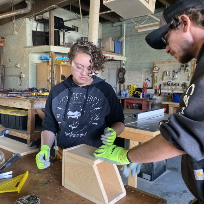 Focused training in progress at ReSOURCE Vermont, where individuals learn valuable construction skills, contributing to workforce development and sustainable job creation.