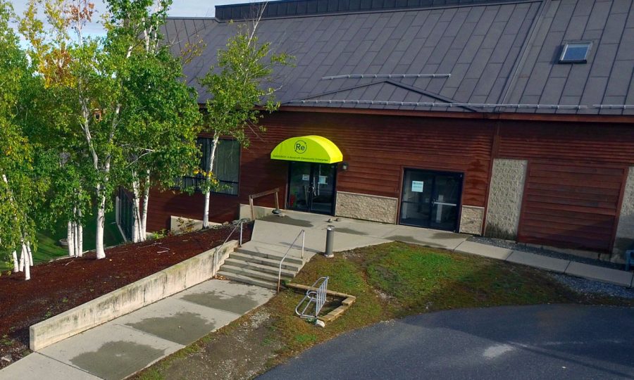 Aerial view of ReSOURCE Thrift Store in Vermont, surrounded by greenery, offering reused clothing, gifts, housewares, and electronics for sustainable shopping.