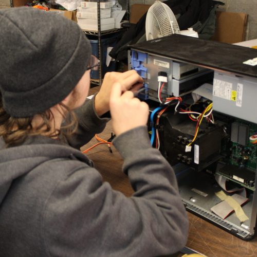 Trainee working on a desktop computer repair