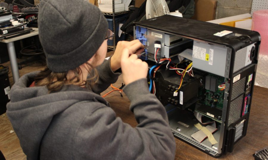 Trainee working on a desktop computer repair